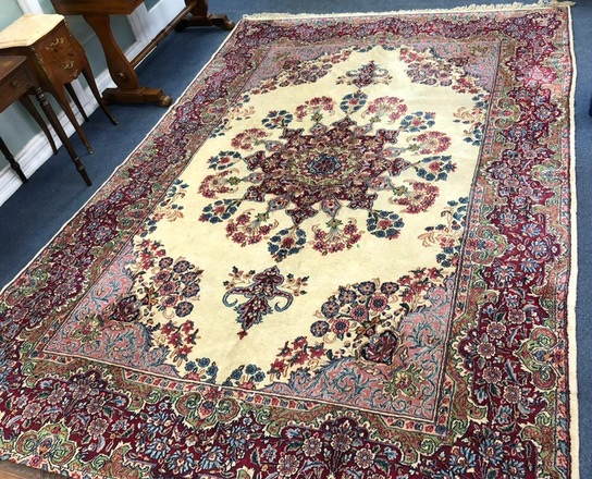 A Kirman red ground carpet, 355 x 243cm